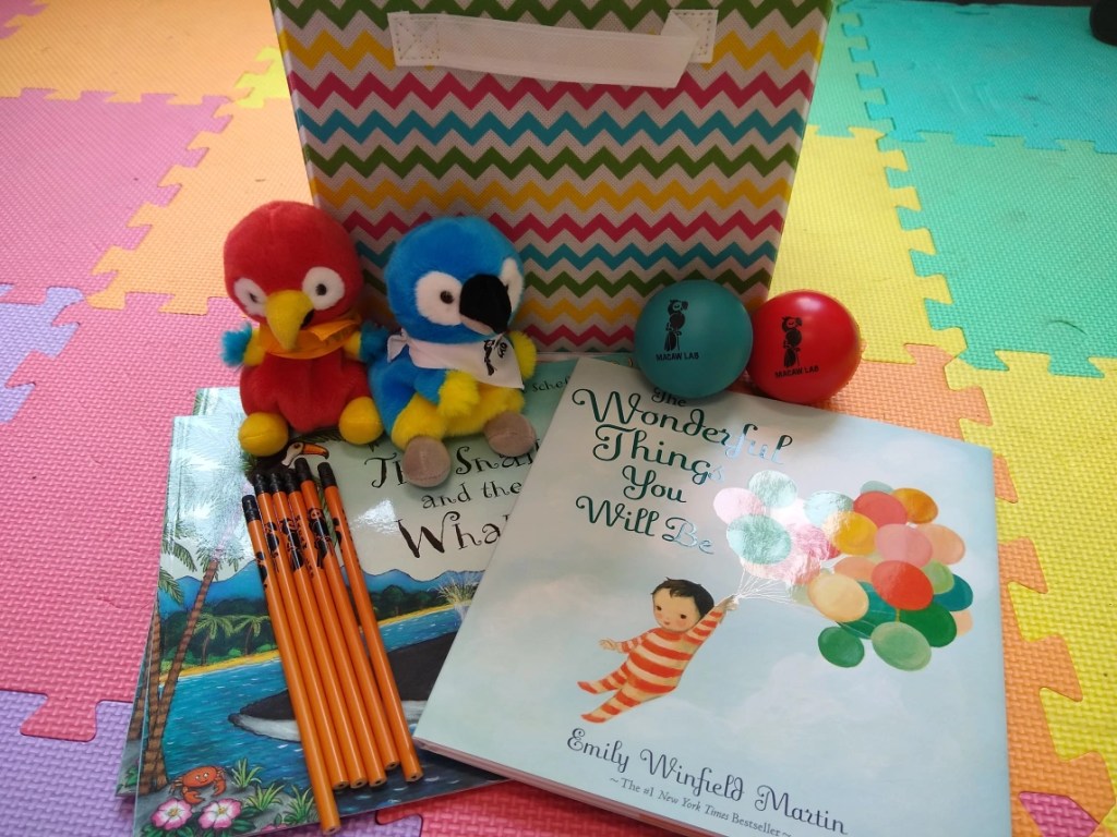 Your child can choose from a book, a stuffed macaw, a stress ball, or a color changing pencil.